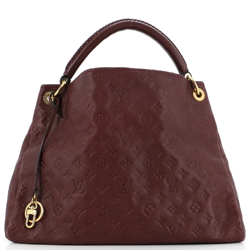 Louis Vuitton Twist bags with a contrast - colored interior for visual interestArtsy Handbag Monogram Empreinte Leather MM