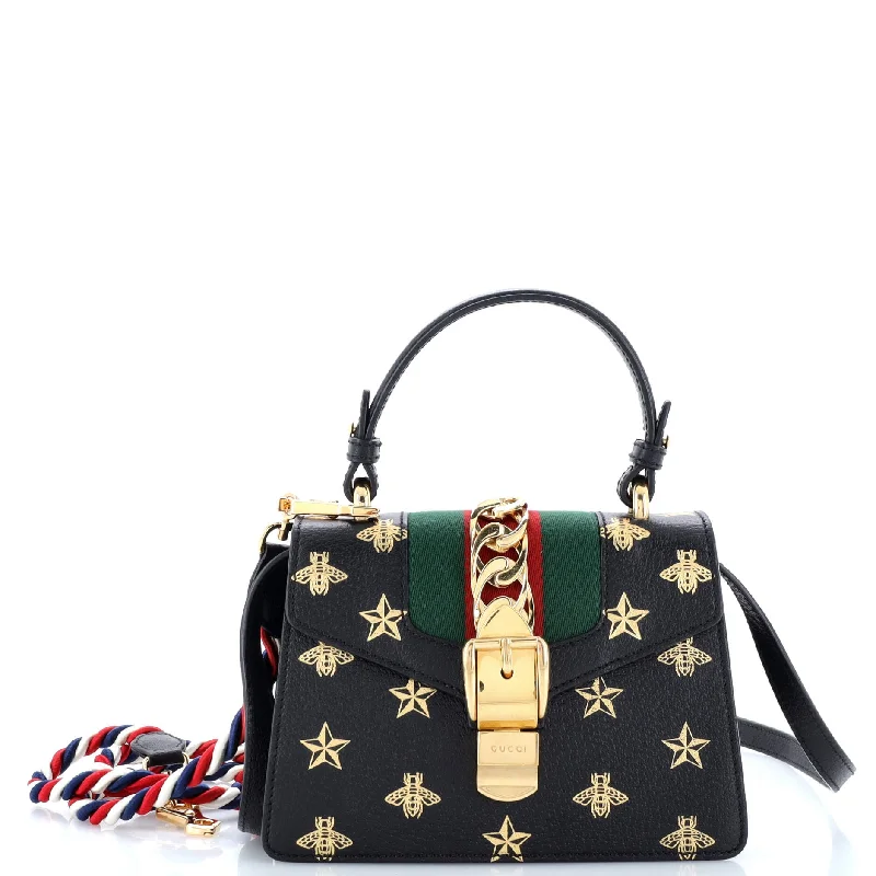 Women Gucci Sylvie bags with a monogram - embossed leatherSylvie Top Handle Bag Printed Leather Mini