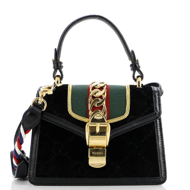 Women Gucci Sylvie bags with a monogram - embossed leatherSylvie Top Handle Bag GG Velvet Mini